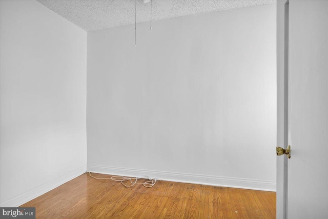 2637 S Bouvier St, Philadelphia, PA 19145 - empty room with a textured ceiling, baseboards, and wood finished floors