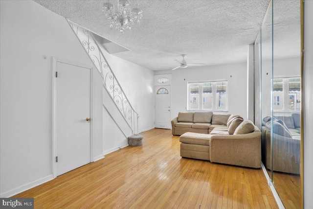 2637 S Bouvier St, Philadelphia, PA 19145 - living area featuring wood-type flooring, stairs, ceiling fan, a textured ceiling, and baseboards