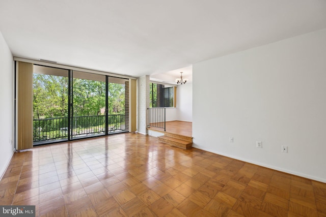 2114 Bonnywood Ln Unit 201, Silver Spring, MD 20902 - empty room with a chandelier, floor to ceiling windows, and baseboards