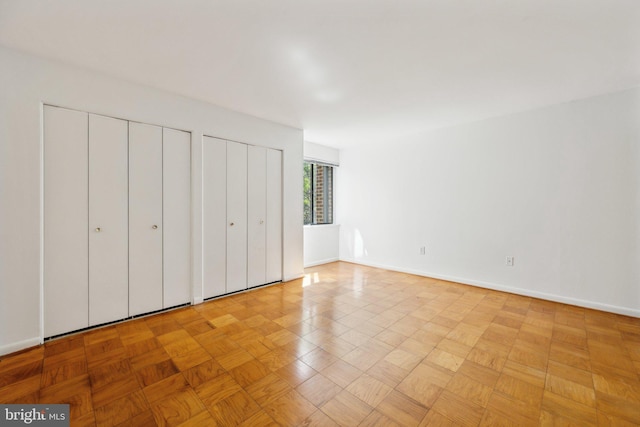 2114 Bonnywood Ln Unit 201, Silver Spring, MD 20902 - unfurnished bedroom with multiple closets and baseboards