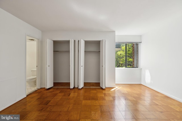 2114 Bonnywood Ln Unit 201, Silver Spring, MD 20902 - unfurnished bedroom with multiple closets, baseboards, and connected bathroom