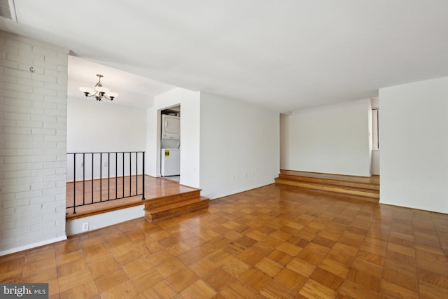 2114 Bonnywood Ln Unit 201, Silver Spring, MD 20902 - spare room with stacked washer / dryer and a chandelier