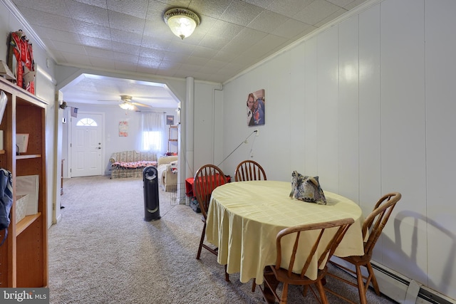 125 S 3rd St, Lebanon, PA 17042 - dining area with crown molding, carpet flooring, a baseboard heating unit, a ceiling fan, and arched walkways
