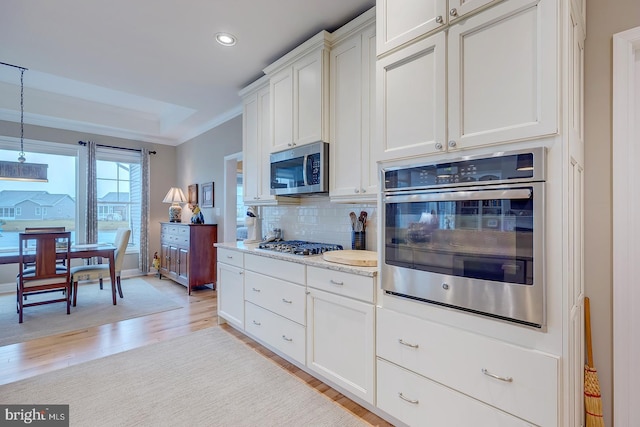 30957 Fowlers Path, Millsboro, DE 19966 - kitchen featuring stainless steel appliances, decorative backsplash, light wood finished floors, recessed lighting, and white cabinetry
