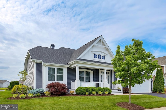 30957 Fowlers Path, Millsboro, DE 19966 - view of front of property with a porch, a front lawn, asphalt driveway, a chimney, and a garage