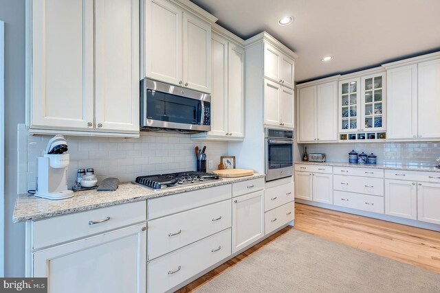30957 Fowlers Path, Millsboro, DE 19966 - kitchen with appliances with stainless steel finishes, white cabinetry, recessed lighting, decorative backsplash, and light wood finished floors
