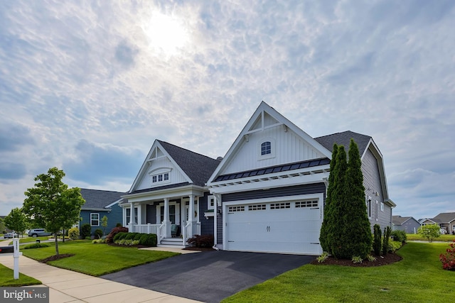 30957 Fowlers Path, Millsboro, DE 19966 - view of front of house featuring asphalt driveway, a porch, a standing seam roof, a front lawn, and a metal roof