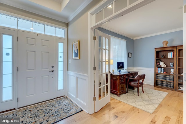 30957 Fowlers Path, Millsboro, DE 19966 - entrance foyer with crown molding, a wainscoted wall, light wood-style floors, and a decorative wall