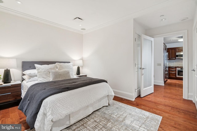 50 S 16th St Unit 4507, Philadelphia, PA 19102 - bedroom featuring ornamental molding, wood finished floors, recessed lighting, and high end fridge