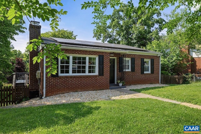 1007 Saint Charles Ave, Charlottesville, VA 22901 - view of front facade with roof mounted solar panels, brick siding, and a chimney