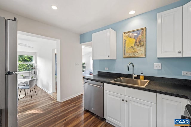1007 Saint Charles Ave, Charlottesville, VA 22901 - kitchen with stainless steel appliances, a sink, dark countertops, dark wood-style floors, and recessed lighting
