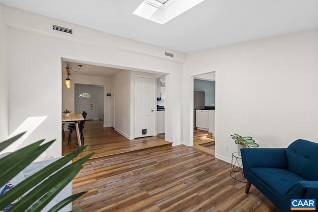 1007 Saint Charles Ave, Charlottesville, VA 22901 - living area with a skylight, wood finished floors, and baseboards