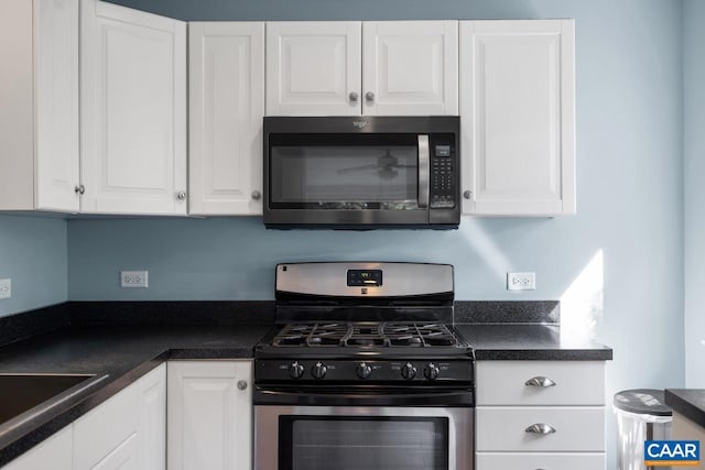 1007 Saint Charles Ave, Charlottesville, VA 22901 - kitchen featuring gas stove, white cabinets, dark countertops, and a sink