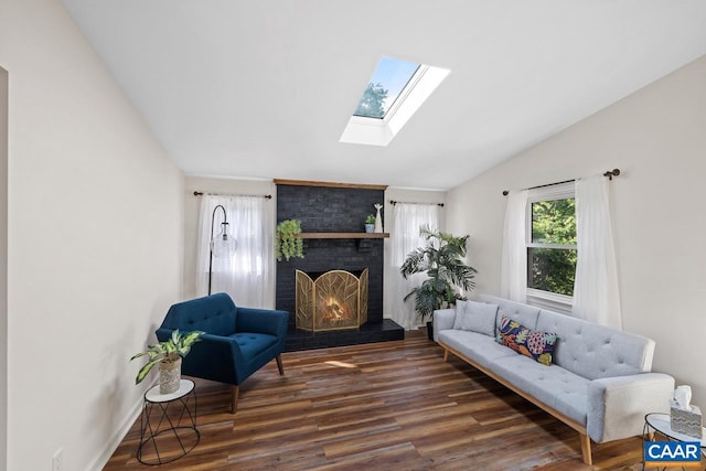 1007 Saint Charles Ave, Charlottesville, VA 22901 - living room with lofted ceiling, a skylight, wood finished floors, and a brick fireplace