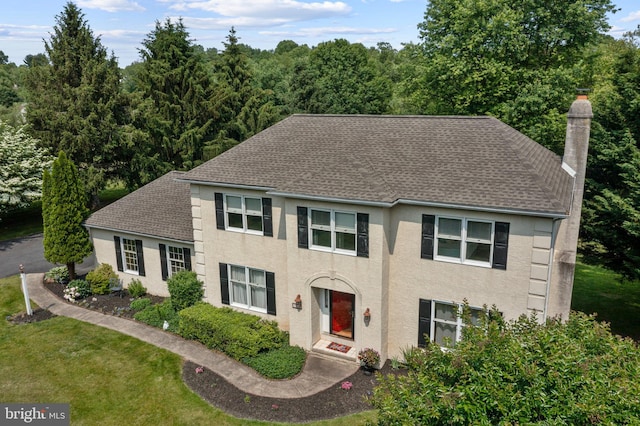 108 Partridge Way, Landenberg, PA 19350 - colonial-style house with roof with shingles, a chimney, stucco siding, and a front yard
