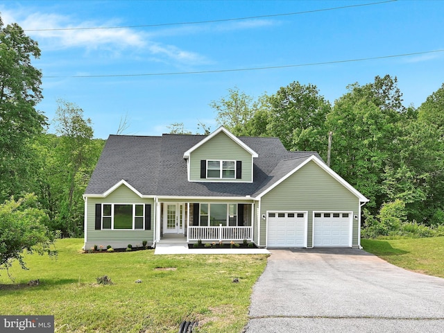 1026 Indian Dr, Auburn, PA 17922 - traditional home with covered porch, asphalt driveway, an attached garage, and a front lawn