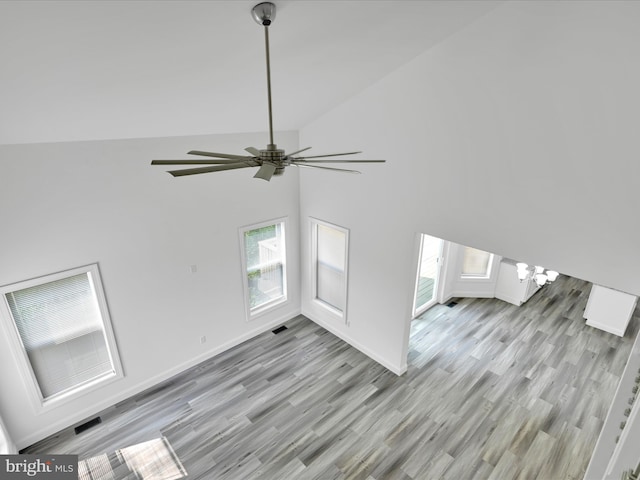1026 Indian Dr, Auburn, PA 17922 - unfurnished living room with a ceiling fan, light wood finished floors, high vaulted ceiling, and baseboards