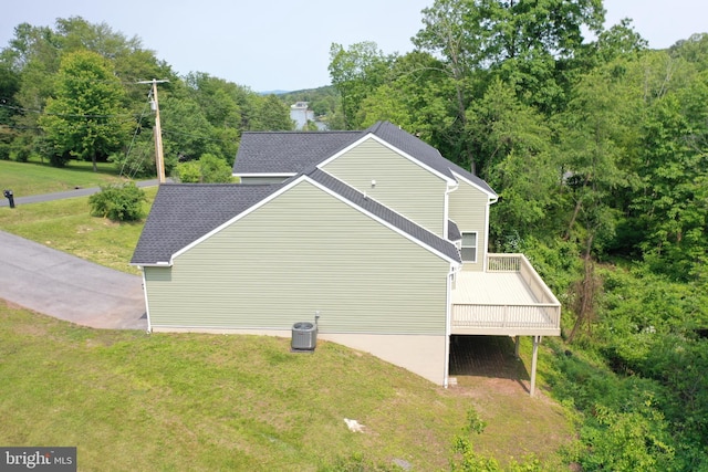 1026 Indian Dr, Auburn, PA 17922 - view of side of property with a wooden deck, a lawn, central AC, and roof with shingles