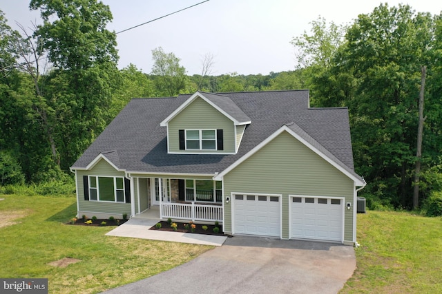 1026 Indian Dr, Auburn, PA 17922 - view of front of home with asphalt driveway, a garage, covered porch, roof with shingles, and a front lawn