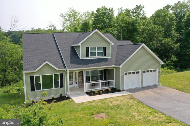 1026 Indian Dr, Auburn, PA 17922 - view of front of property featuring covered porch, an attached garage, asphalt driveway, and a front lawn
