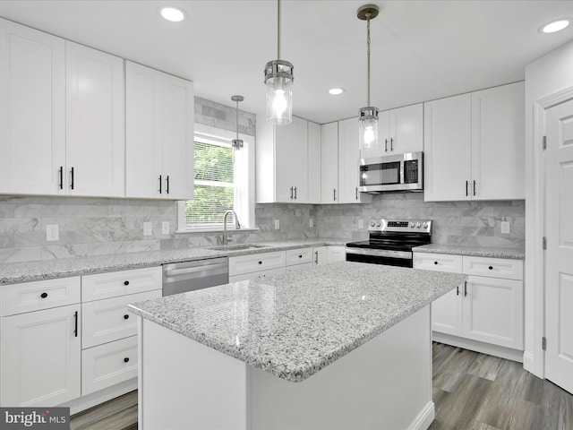 1026 Indian Dr, Auburn, PA 17922 - kitchen featuring stainless steel appliances, a sink, white cabinetry, a center island, and pendant lighting