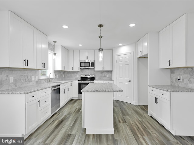 1026 Indian Dr, Auburn, PA 17922 - kitchen with stainless steel appliances, a sink, tasteful backsplash, light stone counters, and recessed lighting