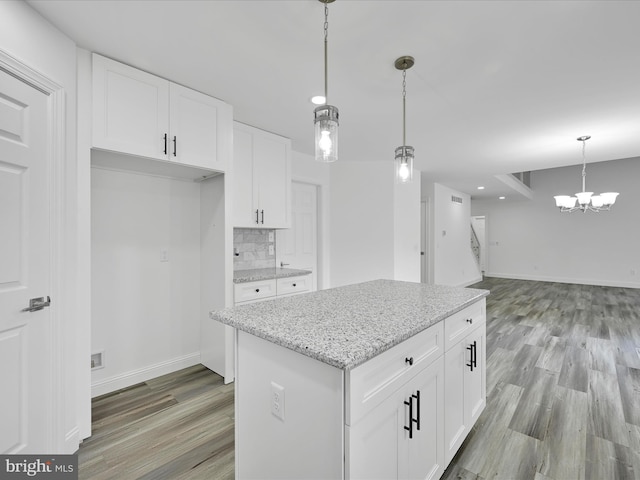 1026 Indian Dr, Auburn, PA 17922 - kitchen with light wood-style floors, a chandelier, pendant lighting, white cabinetry, and light stone counters