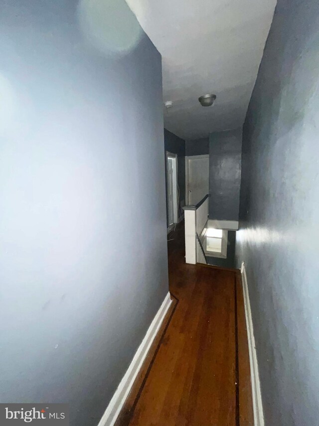 6065 Chester Ave, Philadelphia, PA 19142 - hall featuring an upstairs landing, dark wood-type flooring, and baseboards