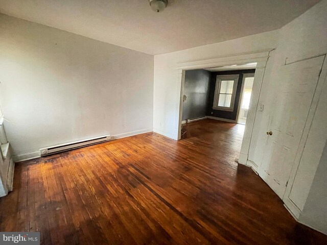 6065 Chester Ave, Philadelphia, PA 19142 - spare room featuring a baseboard heating unit, hardwood / wood-style floors, and baseboards