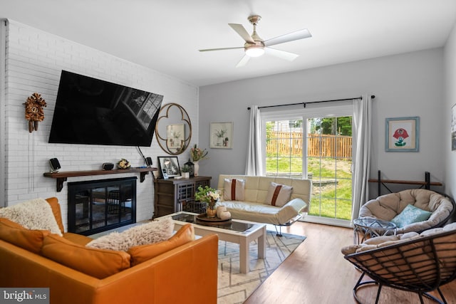 8017 Lake Pleasant Dr, Springfield, VA 22153 - living area featuring ceiling fan, a brick fireplace, wood finished floors, and brick wall