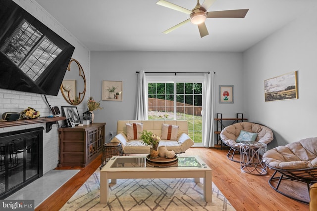 8017 Lake Pleasant Dr, Springfield, VA 22153 - living area with wood finished floors, a ceiling fan, and a fireplace