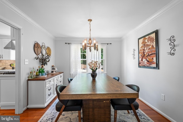 8017 Lake Pleasant Dr, Springfield, VA 22153 - dining space featuring a chandelier, wood finished floors, crown molding, and baseboards