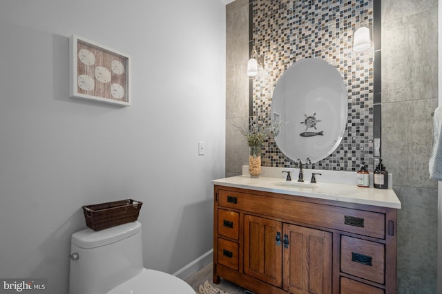 8017 Lake Pleasant Dr, Springfield, VA 22153 - bathroom featuring vanity, toilet, backsplash, and tile walls