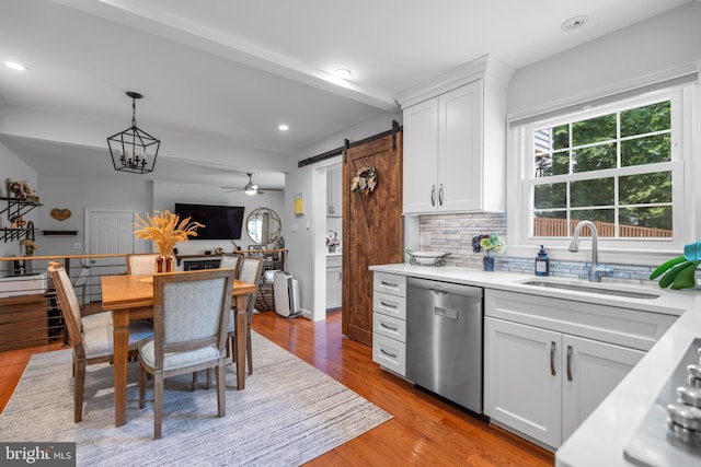 8017 Lake Pleasant Dr, Springfield, VA 22153 - kitchen featuring stainless steel dishwasher, a sink, decorative backsplash, light countertops, and white cabinetry