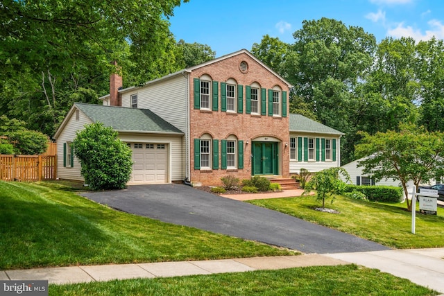 8017 Lake Pleasant Dr, Springfield, VA 22153 - view of front of house featuring a garage, driveway, brick siding, a chimney, and roof with shingles