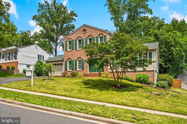 8017 Lake Pleasant Dr, Springfield, VA 22153 - view of front facade with brick siding, driveway, a front lawn, and a garage