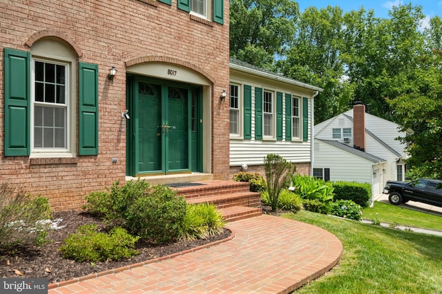 8017 Lake Pleasant Dr, Springfield, VA 22153 - doorway to property featuring a lawn and brick siding