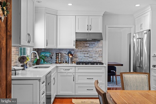 8017 Lake Pleasant Dr, Springfield, VA 22153 - kitchen featuring under cabinet range hood, a sink, stainless steel appliances, light countertops, and white cabinets