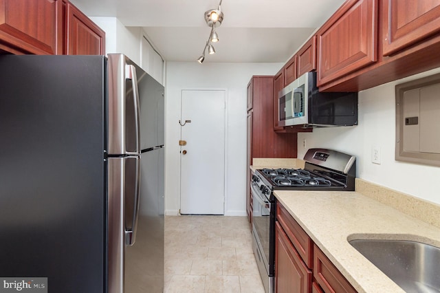 4201 Cathedral Ave NW Unit 910W, Washington, DC 20016 - kitchen with stainless steel appliances, light stone counters, and electric panel