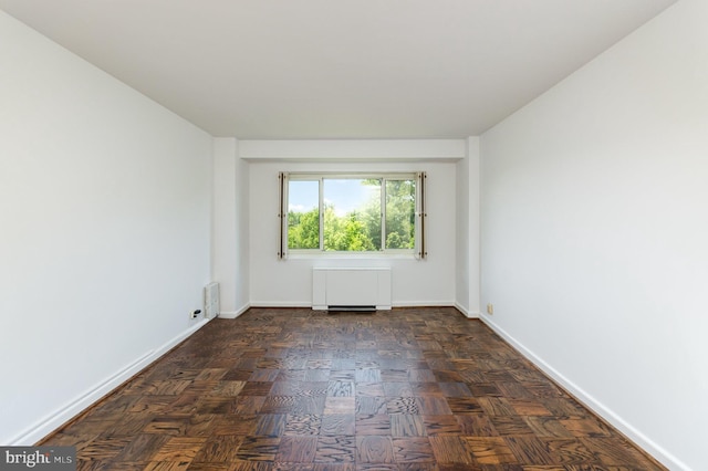 4201 Cathedral Ave NW Unit 910W, Washington, DC 20016 - empty room featuring radiator and baseboards