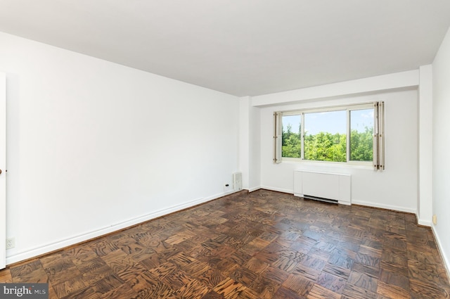 4201 Cathedral Ave NW Unit 910W, Washington, DC 20016 - empty room with radiator and baseboards