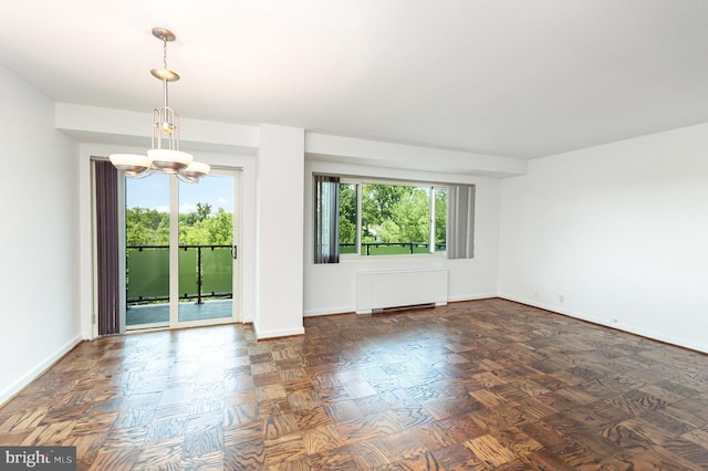 4201 Cathedral Ave NW Unit 910W, Washington, DC 20016 - empty room with radiator heating unit and a chandelier