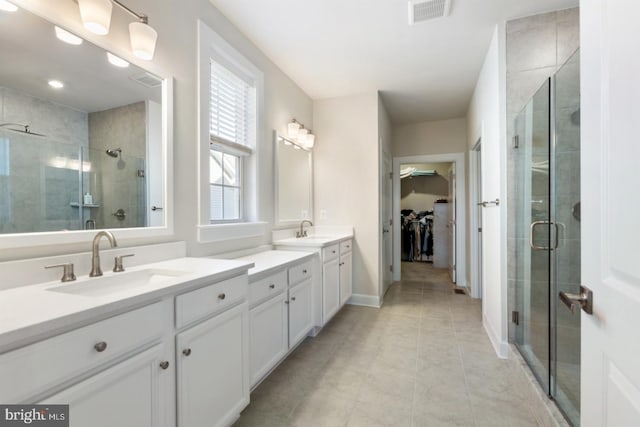 24360 Caldwell Cir, Lewes, DE 19958 - full bathroom with double vanity, a shower stall, a spacious closet, tile patterned floors, and baseboards