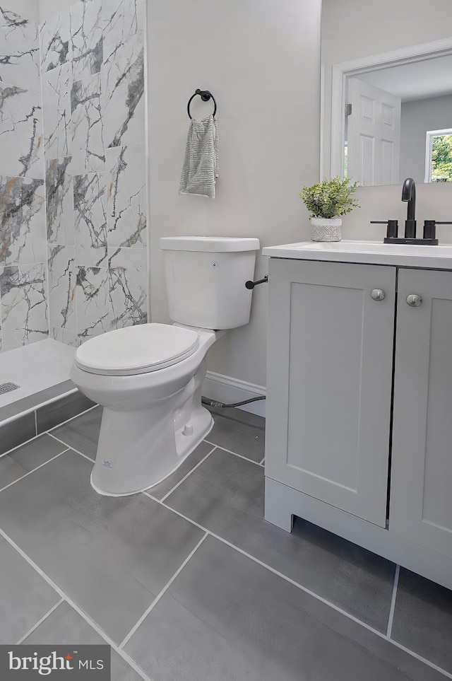 3121 Gwynns Falls Pkwy, Baltimore, MD 21216 - full bath with a stall shower, toilet, vanity, and baseboards
