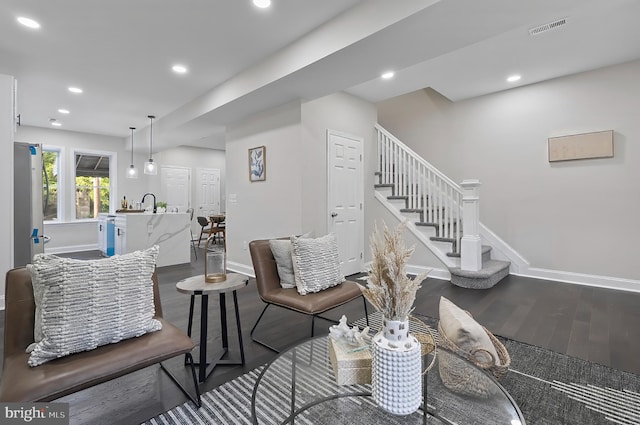 3121 Gwynns Falls Pkwy, Baltimore, MD 21216 - living area with dark wood-style floors, baseboards, recessed lighting, and stairs