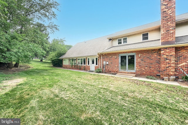 3314 Skyview Dr, Glenville, PA 17329 - rear view of house featuring brick siding, a yard, a chimney, and roof with shingles