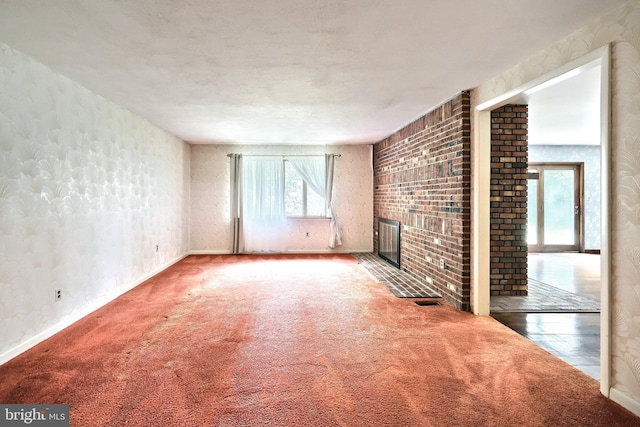 3314 Skyview Dr, Glenville, PA 17329 - unfurnished living room featuring a brick fireplace, carpet floors, and baseboards