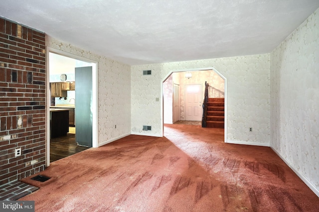 3314 Skyview Dr, Glenville, PA 17329 - empty room featuring carpet, arched walkways, baseboards, stairway, and a sink