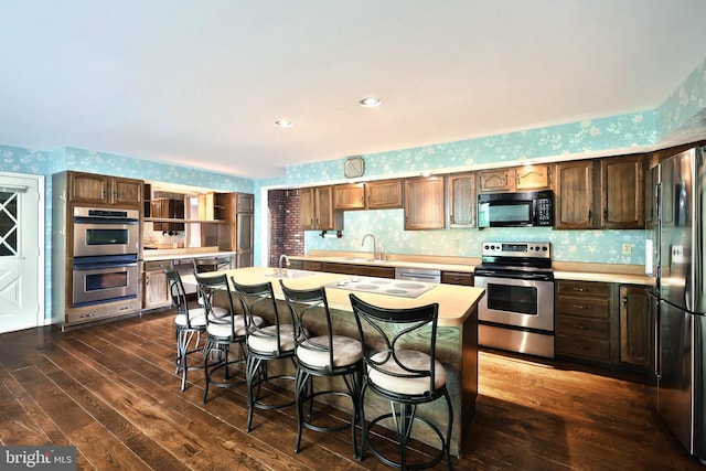 3314 Skyview Dr, Glenville, PA 17329 - kitchen featuring black appliances, wallpapered walls, light countertops, dark wood-type flooring, and a sink
