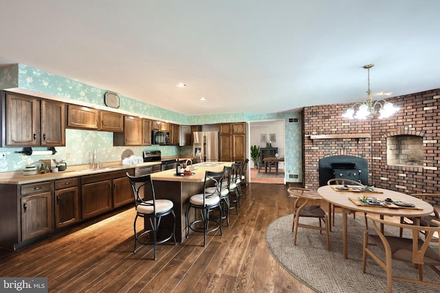 3314 Skyview Dr, Glenville, PA 17329 - kitchen with appliances with stainless steel finishes, a sink, dark wood finished floors, light countertops, and wallpapered walls